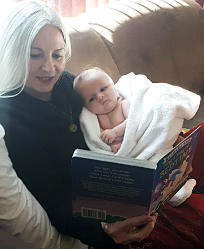 Susan Terry reading to baby